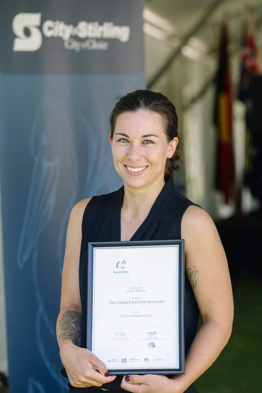 Kelly holding the Active Citizenship Award presented to The Good Chat Foundation