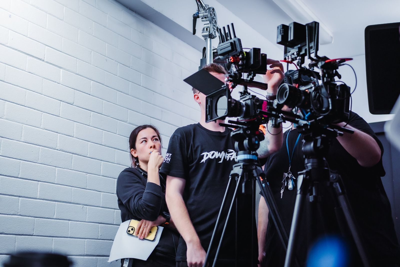 Kelly beside the camera team checking a shot