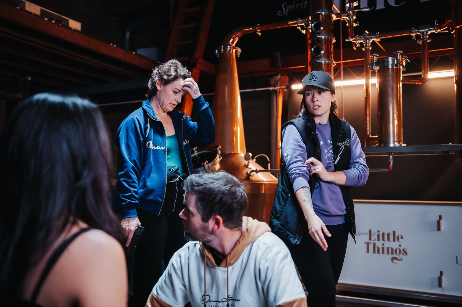 Kelly directing actors in a distillery location